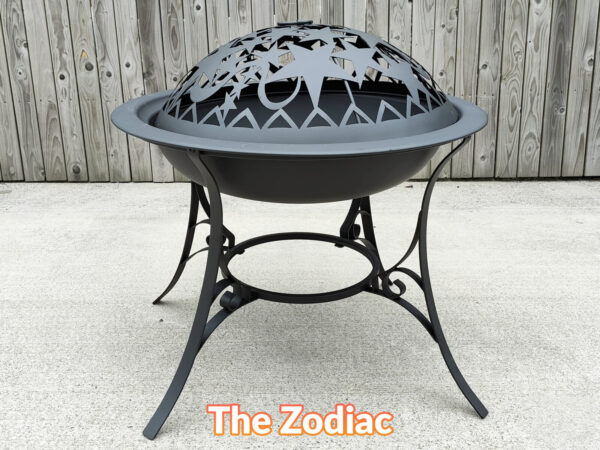 The Zodiac Fire Pit seen face on. It has a star motif on the top, to create interesting shadows. The legs are thin an elegant with a flower deign on them and the fire pit itself is flying-saucer shaped