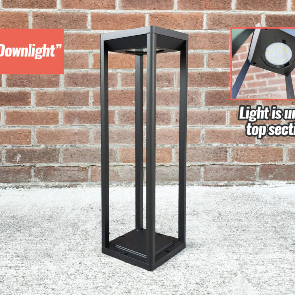 The 'Black Downlight' LED Solar Garden Light against a brick wall