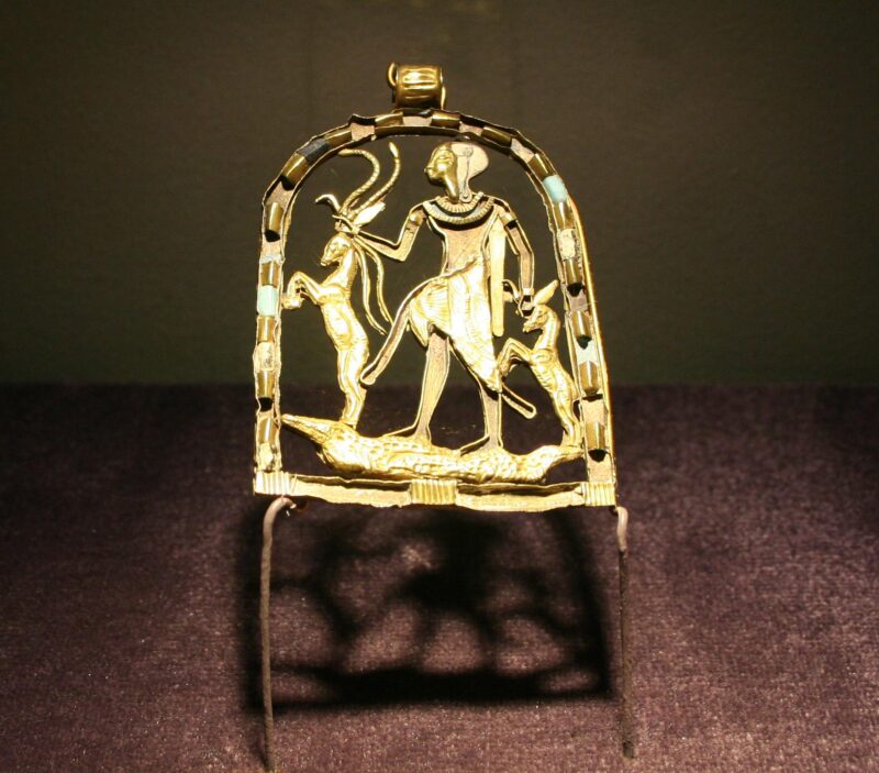 The Greek God Shed in a golden panel. He is facing to the right and carrying to deer by the horns