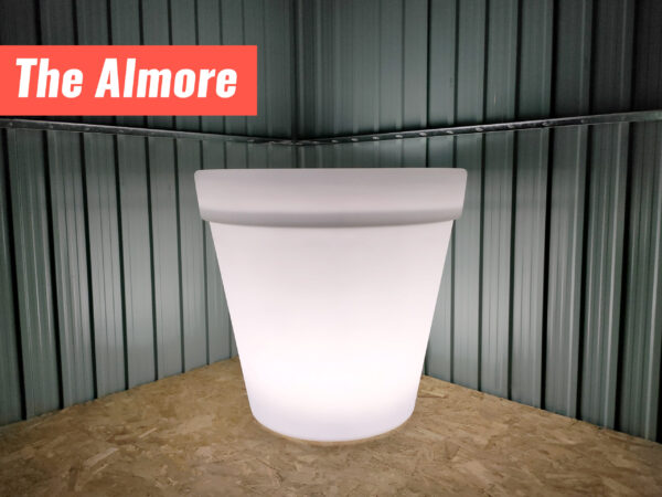 The Almore LED Plant pot glowing bright white inside a steel garden shed