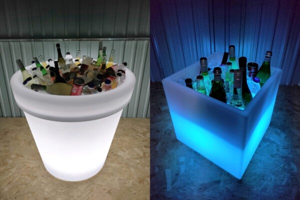 The large Almore plant pot filled with cans of coca cola, water bottles and mountains of ice on one side. To the other side the cube plant pot is glowing blue, it's also filled with drinks and ice.