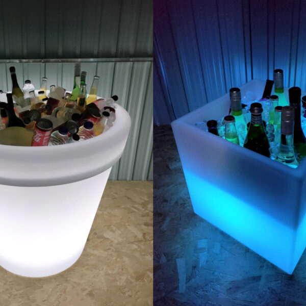 The large Almore plant pot filled with cans of coca cola, water bottles and mountains of ice on one side. To the other side the cube plant pot is glowing blue, it's also filled with drinks and ice.