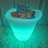 The Petal Flower pot filled with cans of soft drink and crisps. It is glowing teal