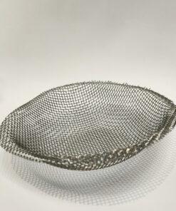 An upside-down silver Mesh dome for a camping stove on a white backdrop