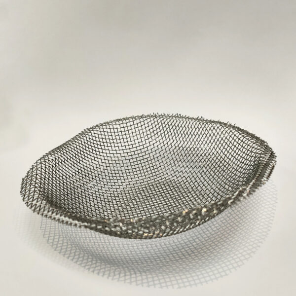 An upside-down silver Mesh dome for a camping stove on a white backdrop