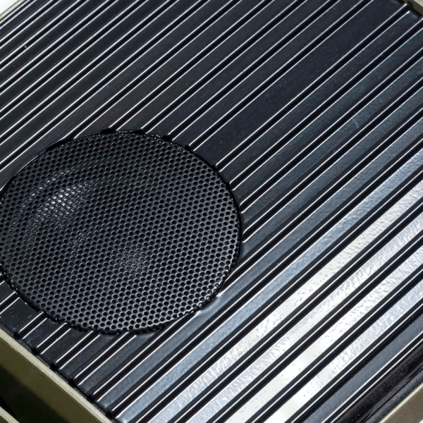 A close up look at the speaker segment of this infrared heater with speaker. It is black and circular.
