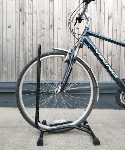 A close up, side view of the bike stand with a bicycle parked into it.