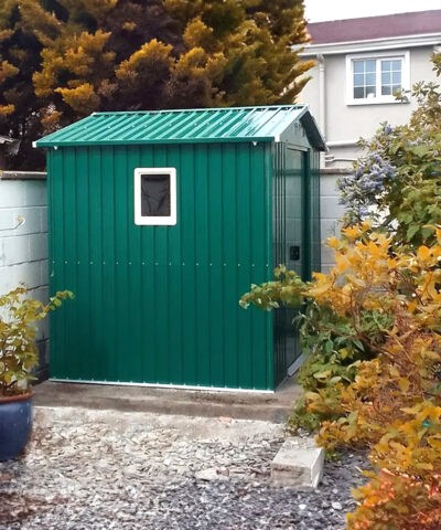 The side of the 8f x 6ft with a window in a small garden