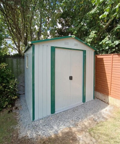 8ft x 6ft off white garden shed under a tree in a garden