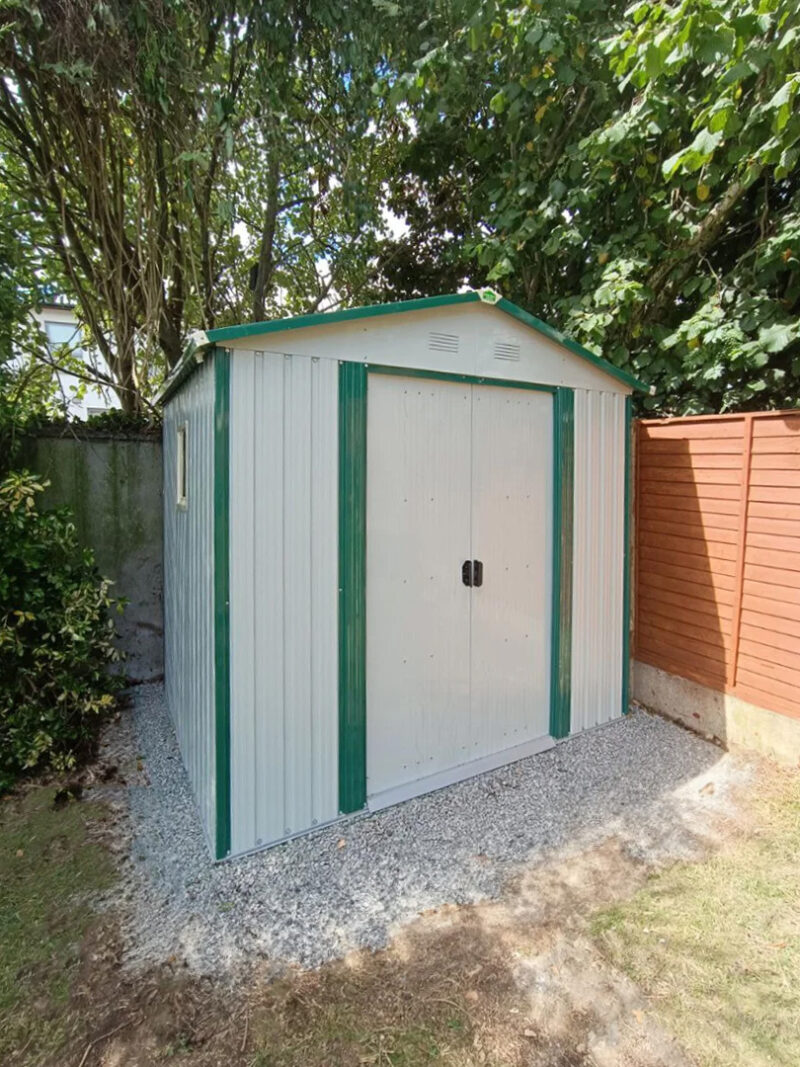 8ft x 6ft off white garden shed under a tree in a garden