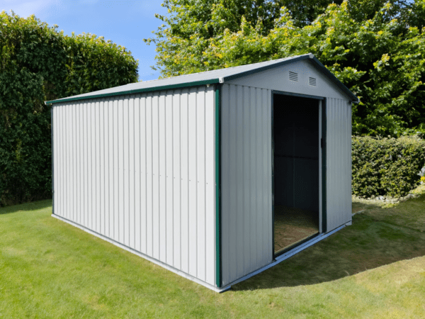 An off-white version of the 9ft x 10ft steel garden shed sitting in a grassy garden. There are large bushes in the back of the scene