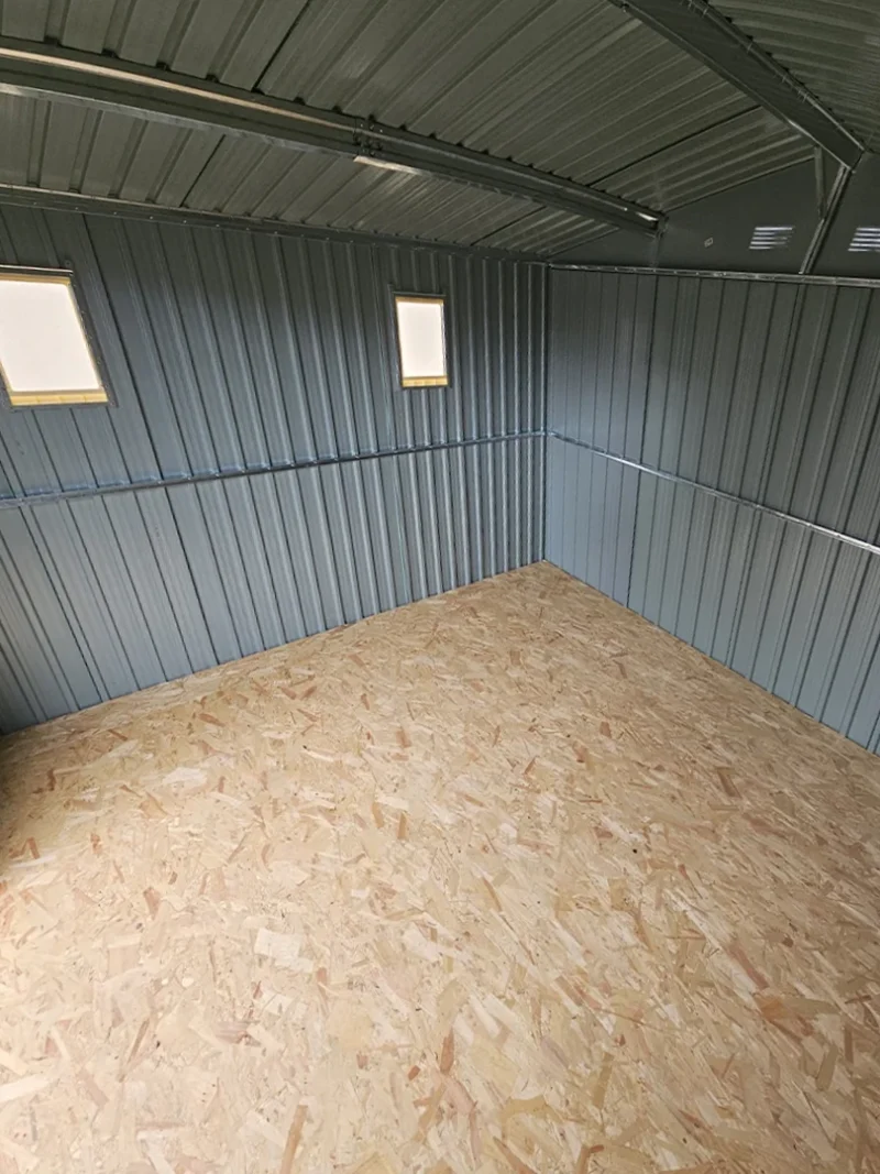 An interior view of the 9ft x 10ft showing two installed windows on the side wall