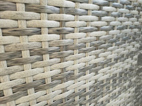 A close up view of the interwoven rattan material that makes up the furniture