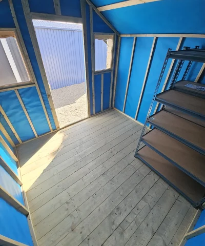 Inside the wooden overhang shed