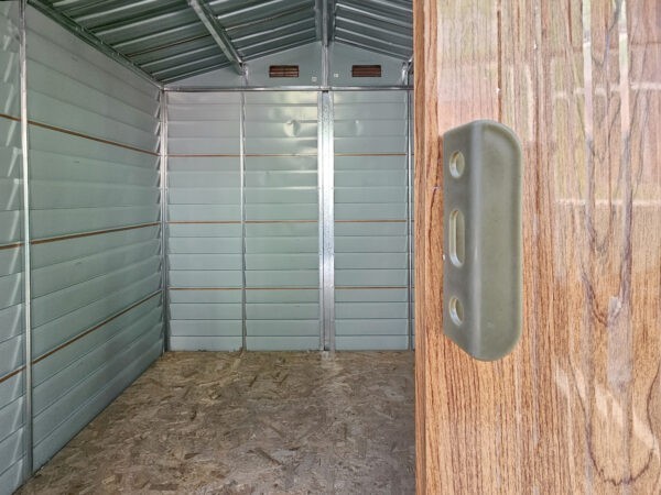The inside of the woodgrain shed as seen from the door frame