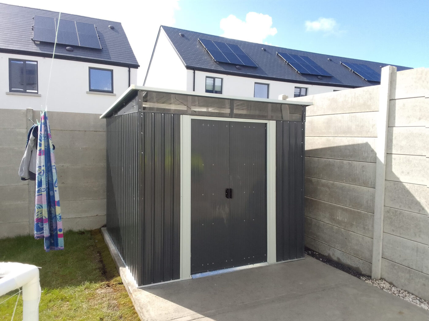 A pent shed built against a wall