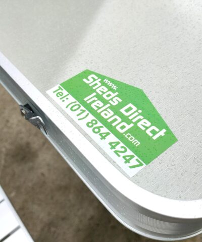 The Sheds Direct Ireland Logo on one of the corners of the picnic table. The logo is bright green and it has the phone number below it (018644247)