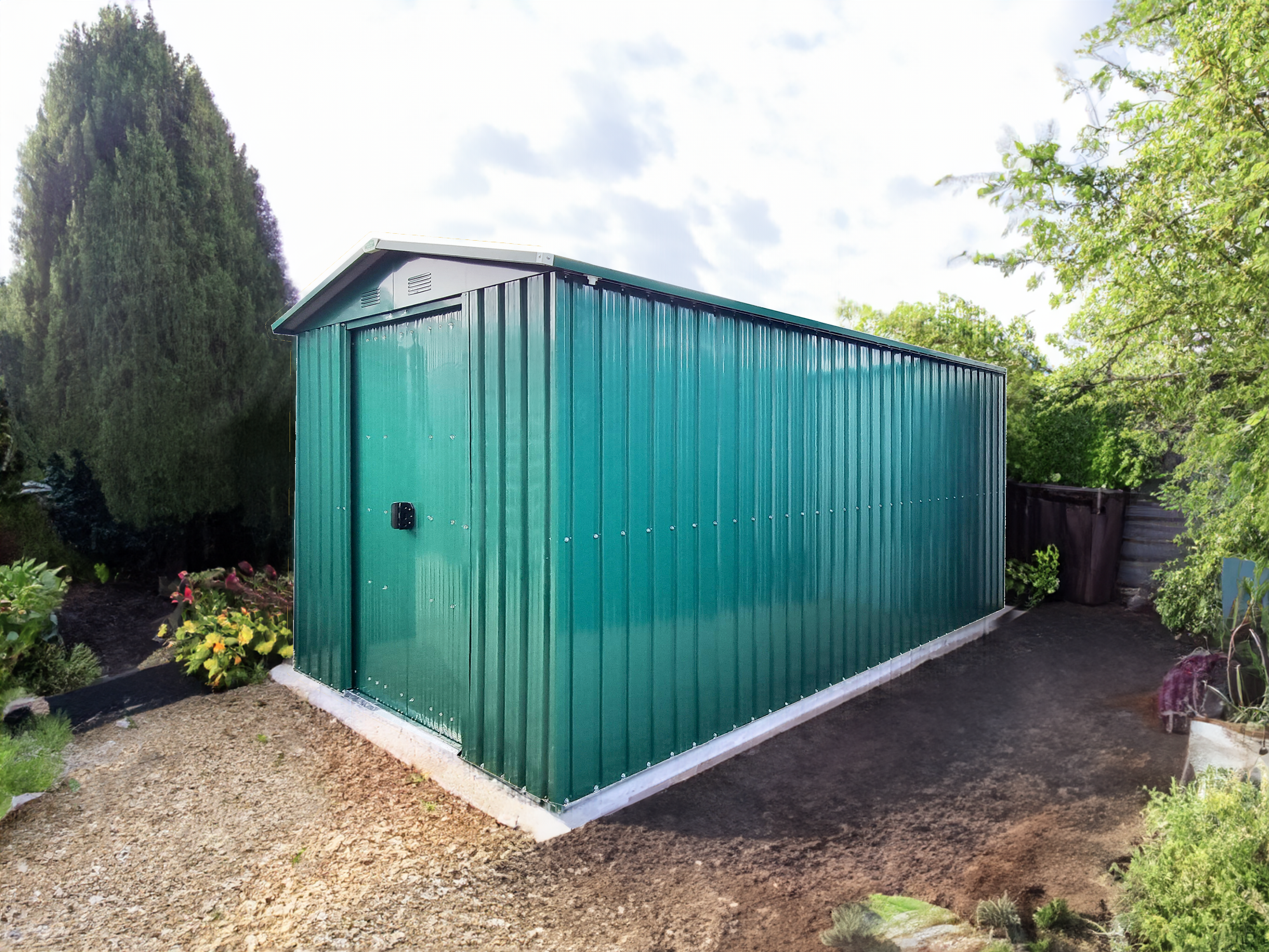 The 6ft wide x 12ft deep steel garden shed in green in a garden