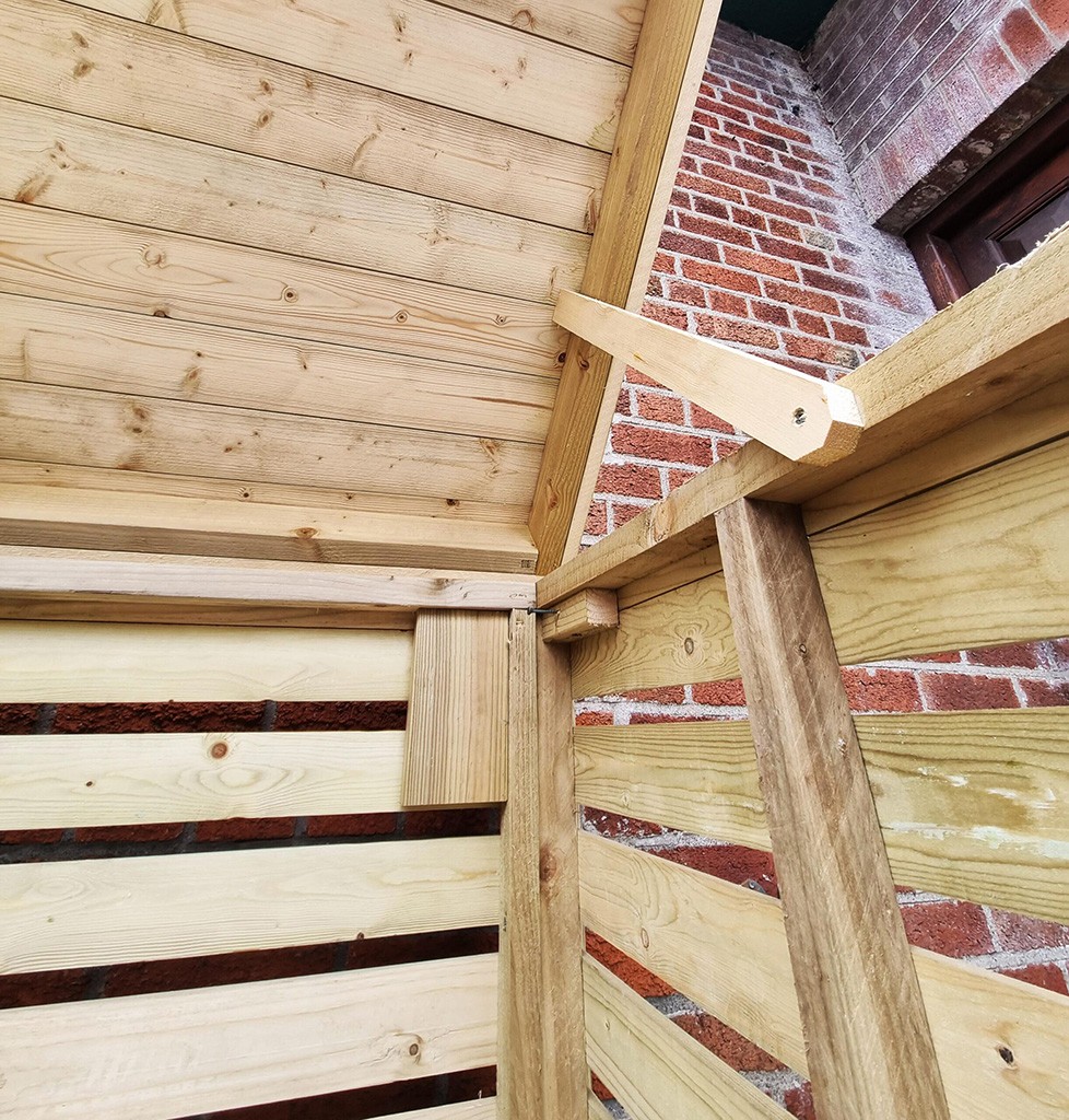 The inside hinge on the wooden bin store
