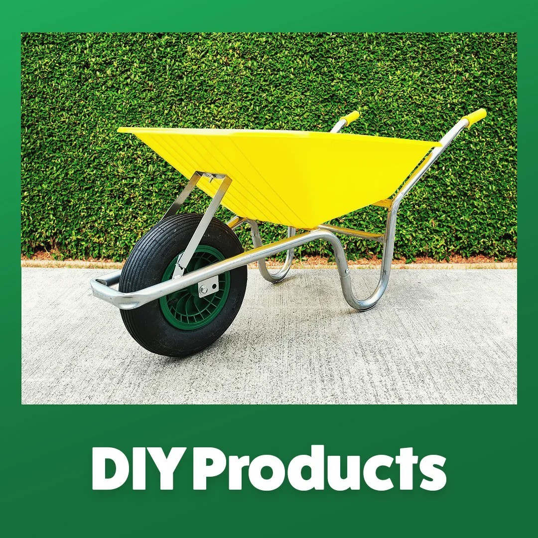 DIY Products. yellow wheelbarrow in front of hedges on concrete pavement