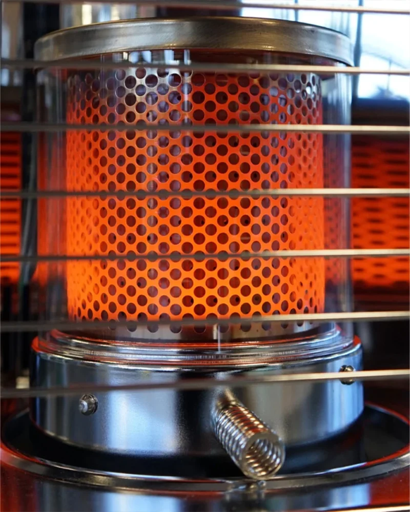 The wick inside the globe glowing orange with heat