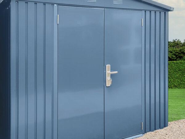 Another angle of the big blu shed sitting in a garden