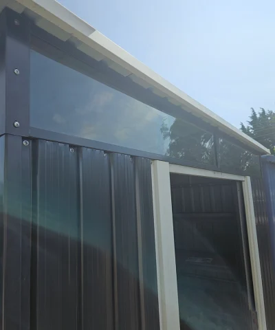 The full width window above the door of the shed