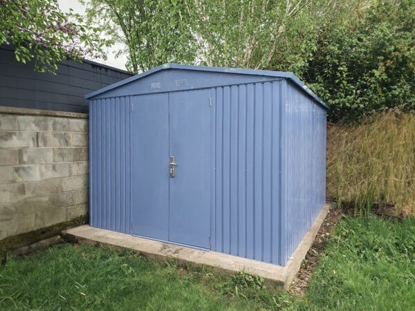The Big Blue shed in the corner of a garden