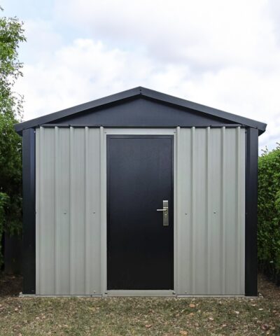 The off-white and black heavy duty shed in a garden.