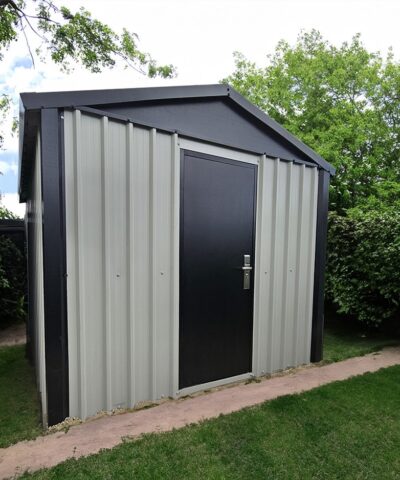 The Heavy Duty Shed in a garden, surrounded by bushes and tall trees