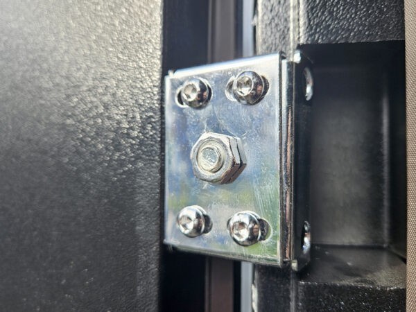 A close up, detailed view of the hinge on the door