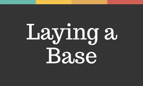 A grey image that reads 'laying a base' in white font