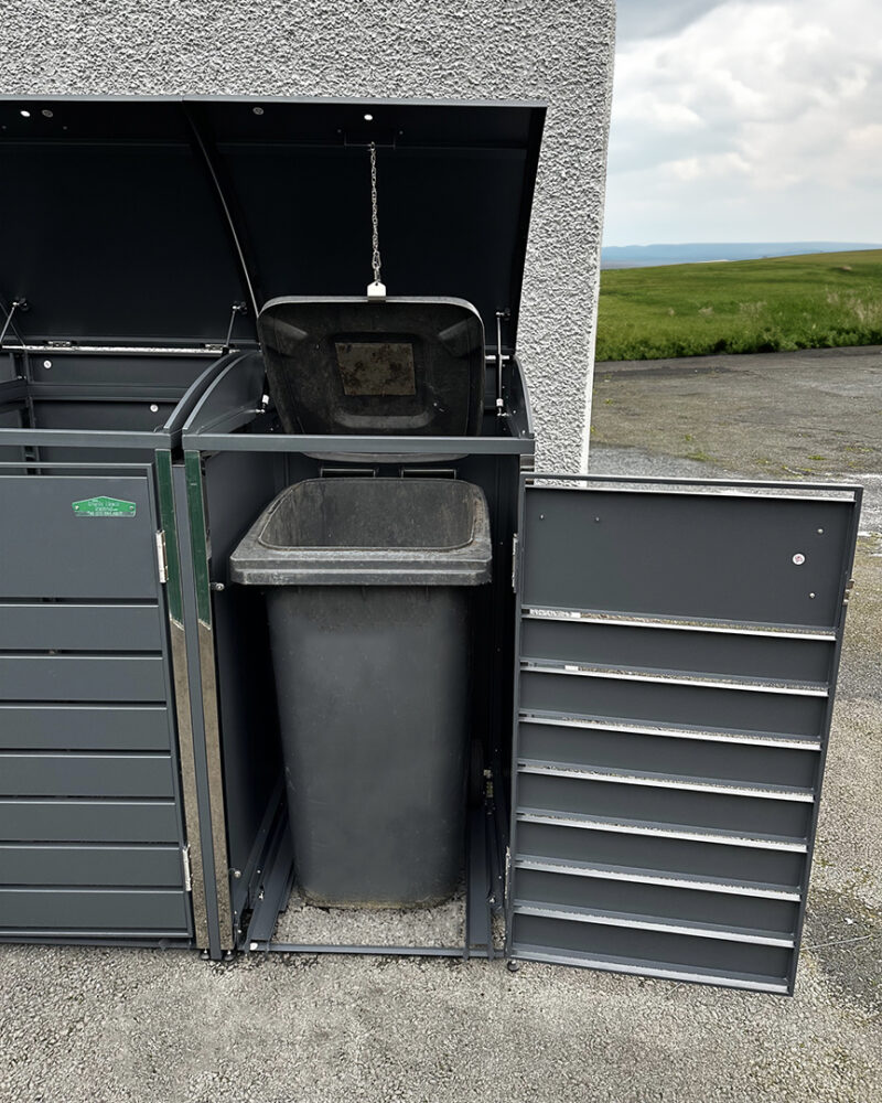 The modular bin store with a door opening showing a stored wheelie bin