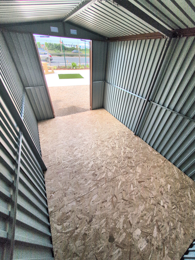 Interior of the premium woodgrain 8ft x 12ft steel shed, looking outwards