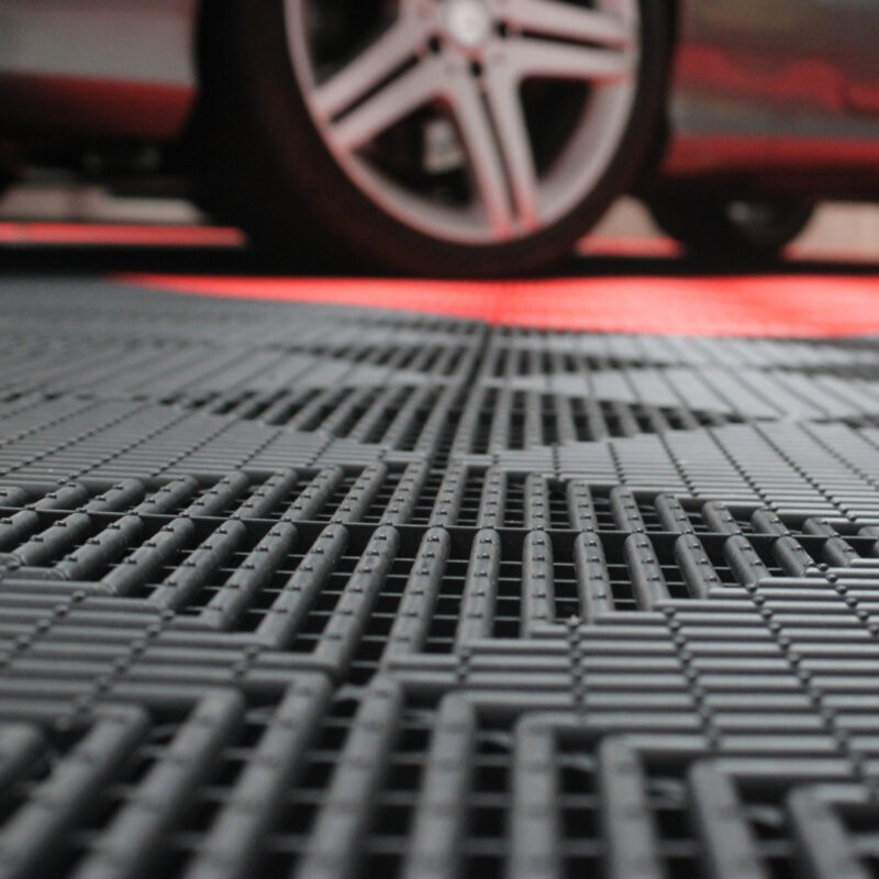 A car parked on top of the a-grip tiles