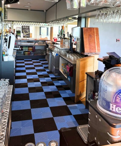 A pub with black and blue checkerboard a-grip flooring