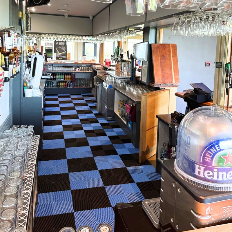 A pub with black and blue checkerboard a-grip flooring