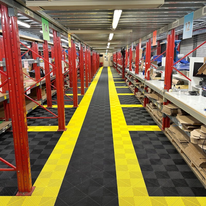A warehouse with black and yellow tiled flooring
