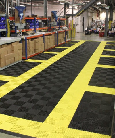 A warehouse with black and yellow tiled flooring