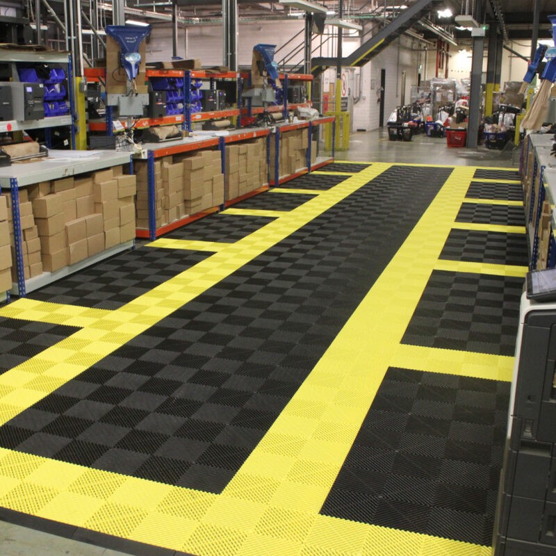A warehouse with black and yellow tiled flooring