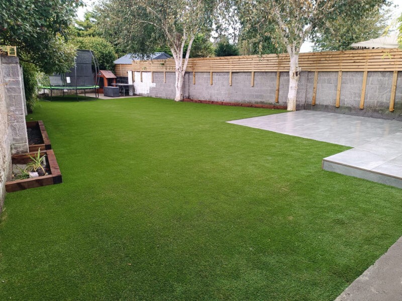 A Dublin garden of artificial grass with a trampoline and shed on it