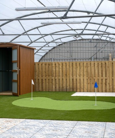 A woodgrain garden shed sitting on artificial grass