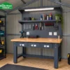 Heavy-duty steel workbench set up as a workshop inside a steel garden shed